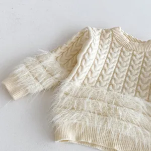 Infant cable knit sweater detail showing fluffy trim and cozy texture for cold weather.
