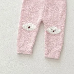 Pink fuzzy baby pants detail shot, cozy coral fleece material with cute bear knee patches.