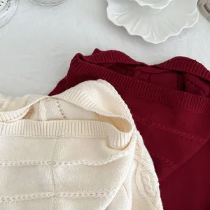 Detailed close-up of cozy children's knitted hooded sweater texture and fine cable knit craft.