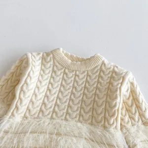 Infant cable knit sweater detail showing cozy fleece hem, soft winter warm baby top fabric texture.