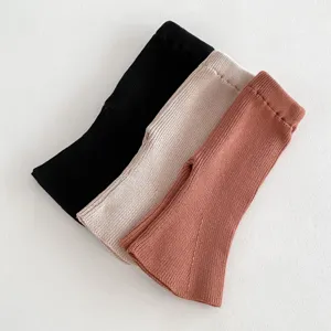 Infant knit ribbed flare pants detail view, soft cotton blend material, three color options.
