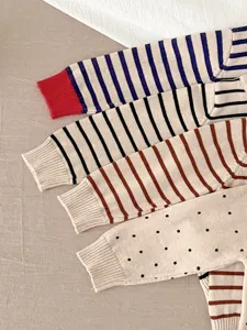 Baby gebreide trui detail met strepen en stippen, zachte katoenen top met lange mouwen.
