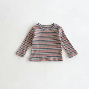 Close-up detail of infant long sleeve striped ribbed t-shirt fabric and hem label.