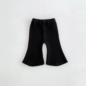 Detailed view of black knitted baby flare pants, soft cotton ribbed fabric, comfortable fit.