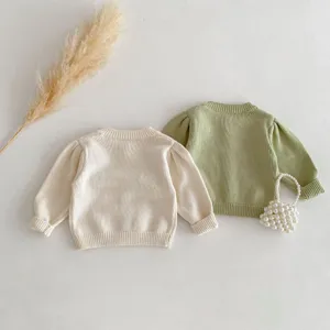 Infant baby knitted sweater detail view, cute puff long sleeves, soft cotton fabric.