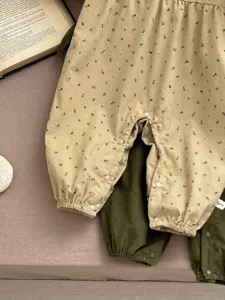 Infant baby floral romper detail shot, long sleeve cotton crawler with snap closure.