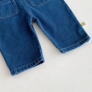 Detailed shot of dark blue baby denim trousers featuring back pockets and cuffed hem tag design.