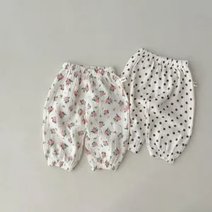 Infant baby gauze mosquito pants detail view, soft floral and polka dot toddler trousers.