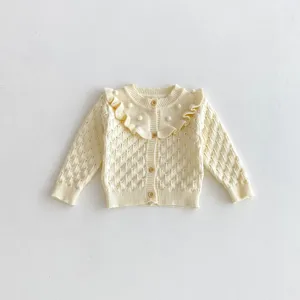 Baby knit cardigan detail, cream color, cute ruffle collar, hollow-out knit pattern.