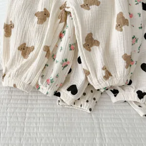 Close-up details of infant gauze anti-mosquito pants featuring cute bear and floral prints.