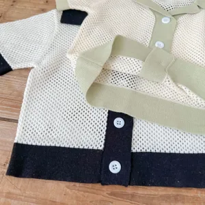 Infant baby girl knit cardigan detail shot, hollow out cotton yarn sweater with contrast color.
