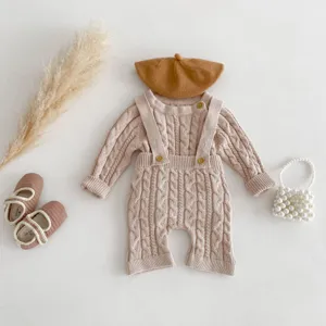 Detailed view of cute baby knitted romper set with beret, cozy aesthetic flat lay.