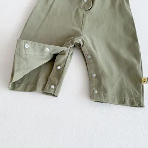 Detailed shot of baby olive green cotton casual pants with snap button crotch design.