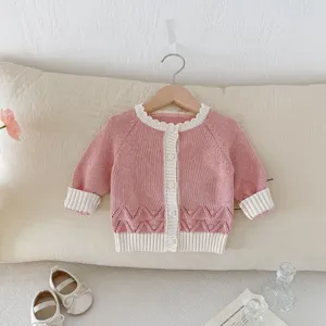 Baby pink knit cardigan sweater for infant girls, cozy cute handmade style outerwear.