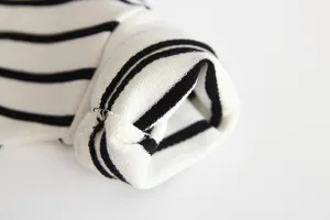 Infant black and white striped cotton long sleeve shirt cuff detail close up fabric