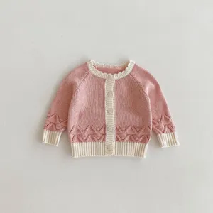 Pink knit cardigan detail, cute hollow pattern, white ribbed trim, single breasted buttons.