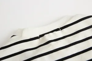 Infant long sleeve striped t-shirt collar detail shot, soft cotton material close up view.