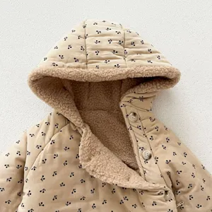 Close-up detail of baby winter hooded jumpsuit in khaki corduroy with cute cherry print.