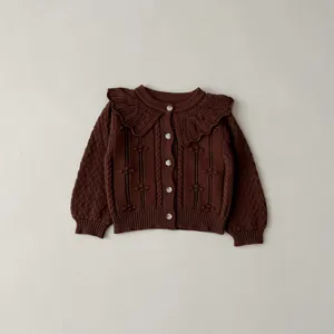 Baby girl brown knit cardigan with doll collar and buttons, detailed cable pattern texture.