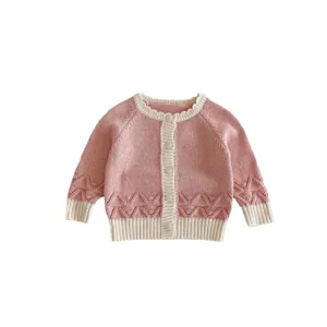 Adorable baby girl pink knit cardigan sweater with sweet bobbles and button closure.