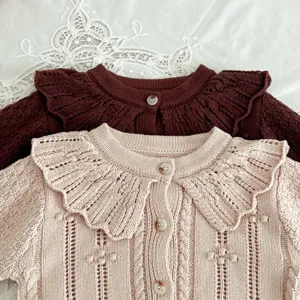 Close-up view of toddler knitted cardigan featuring a cute doll collar and soft yarn.