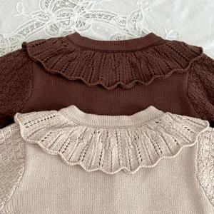 Detailed view of baby knitted cardigan, cute doll collar, soft cotton knit, cozy children sweater