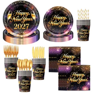 Black and gold New Year party tableware set with paper plates, cups, napkins and cutlery.