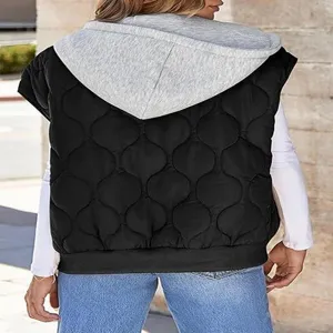 Close-up detail of the black quilted hooded vest featuring contrast grey hood and stitching.