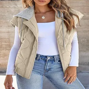 Closeup detail of women's quilted hooded vest showing textured fabric and grey drawstring.