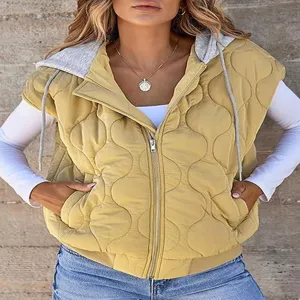 Close-up detail of the women's yellow quilted hooded vest, featuring front zip and drawstring.