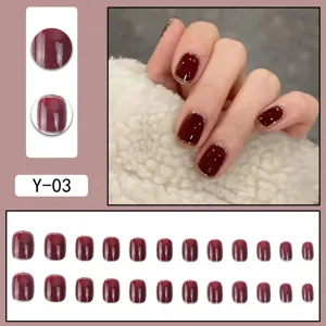 Detailed view of dark red press-on nails with silver glitter edge, showcasing full set and hand wear.