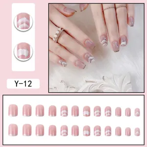 Detailed view of removable press-on nails with gradient blush effect and silver glitter tips.