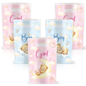 Details view of teddy bear gender reveal party goody bags, pink and blue bags for baby baptism.