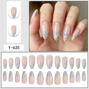 Almond press-on nails detail showcase with colorful small floral design and clear nude base.