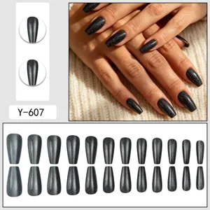 Close-up detail of dark grey cat-eye press-on nails, showcasing full size set and hand wear.