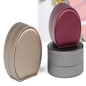 Detailed view of the elegant oval brushed leather jewelry box, perfect for rings and necklaces.
