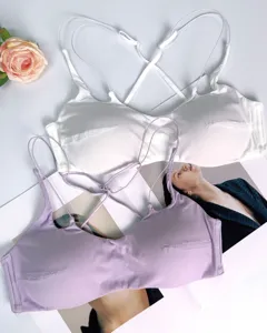 Detailed shot of sexy wireless bralette with thin cross straps in white and lavender colors.