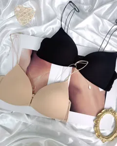 Close-up detail of front closure thin strap wireless push-up bra, smooth silk background.