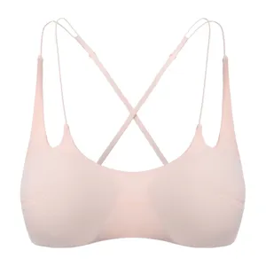 Comfortable pink wireless bra with thin cross straps, seamless design for daily wear.