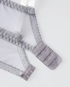 Close-up detail of women's grey mesh bra back closure with adjustable hooks and soft fabric.