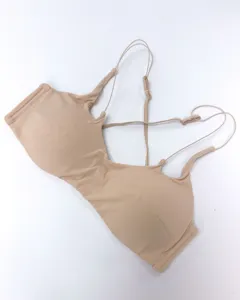 Sexy wireless padded bralette with thin cross back straps in nude color, detailed look.