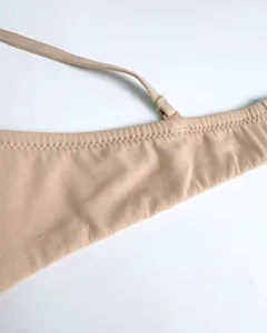 Close-up view of nude wireless bra strap and fine stitching detail for daily comfort.