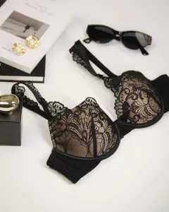 Detailed shot of exquisite black and nude lace bra with deep V design and elegant floral patterns.
