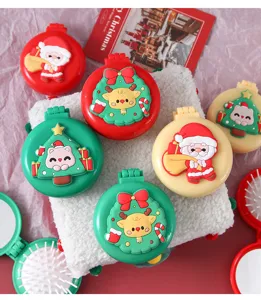 Detailed view of cute foldable Christmas air cushion hairbrushes with 3D cartoon Santa and reindeer designs.
