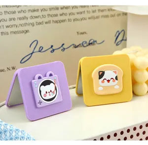 Mignon miroir de maquillage pliable double face au style dessin animé pour voyage et bureau.