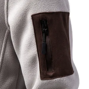 Close-up detail of sleeve pocket on mens fleece jacket, showing soft texture and suede design.