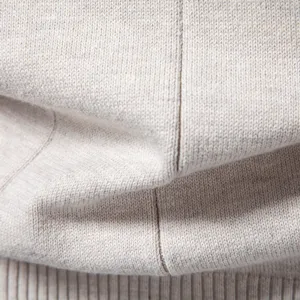 Detailansicht des reinen Baumwoll-Herrenpullovers, weiche Stofftextur und Rippsaum.