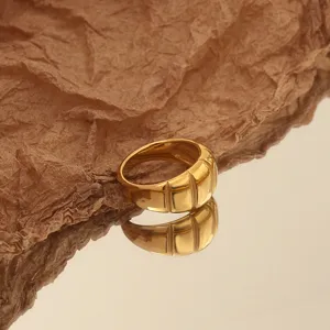 Chunky gold statement ring with modern ribbed design, stylish fashion jewelry for women everyday.