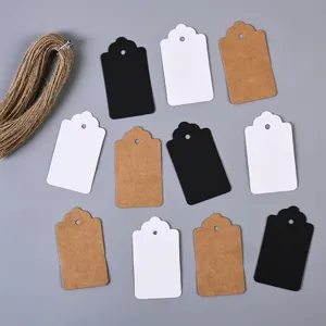 Blank kraft paper hang tags detail view showing assorted black white and brown cards with twine.