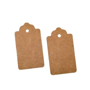 Blank brown kraft paper tags with scalloped top and hole punch for clothing, gifts and pricing.